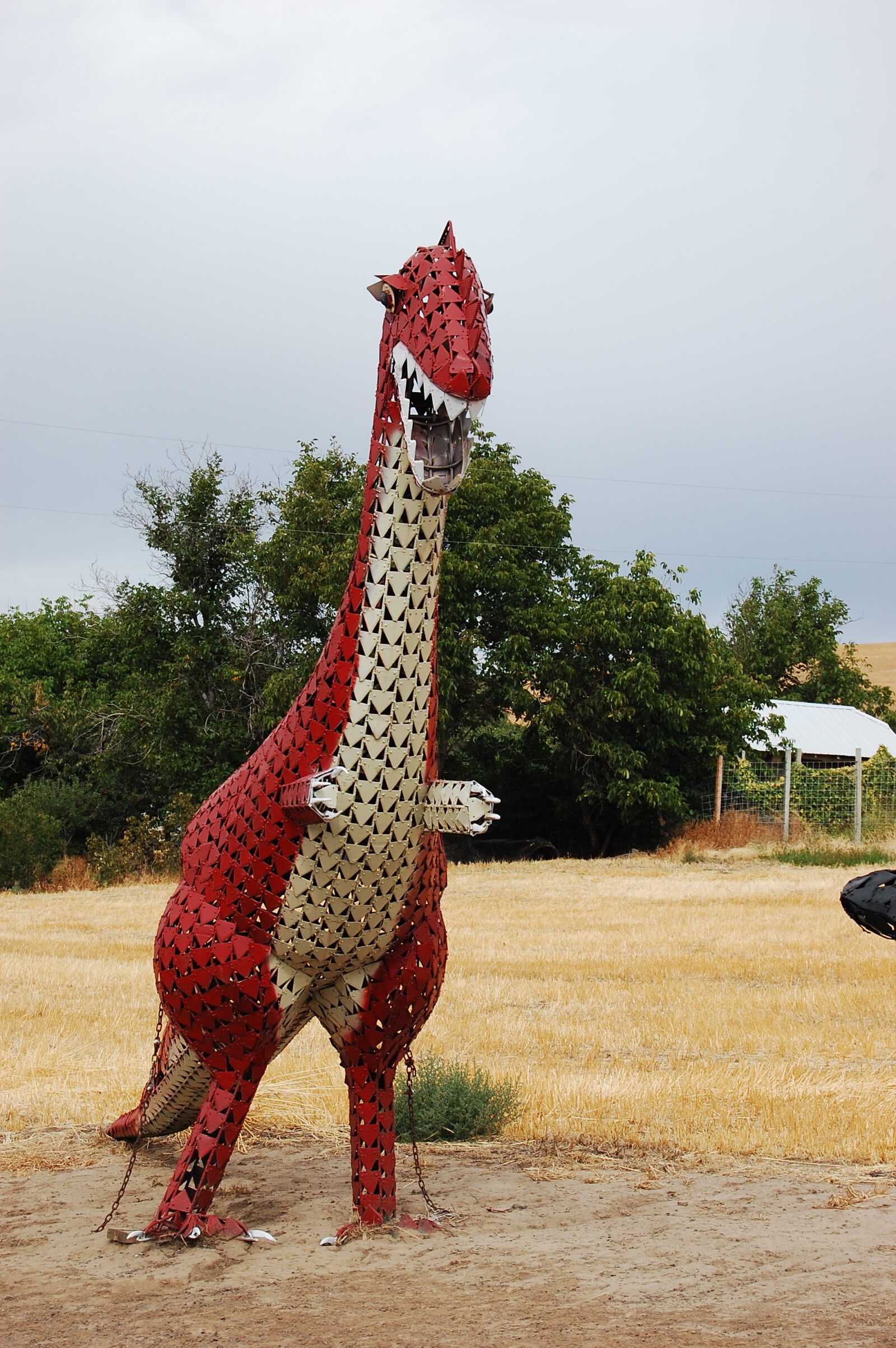 Rawwwr..  Red metal T-Rex cheering the bikers on.