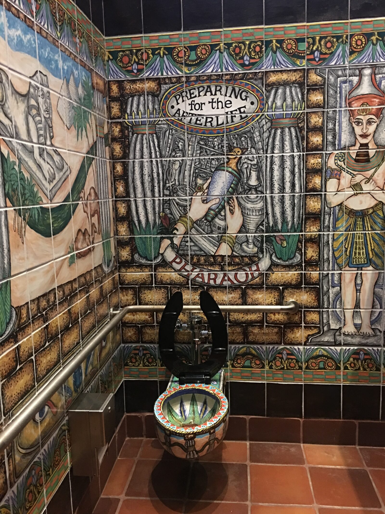 The most ornate bathroom stall - Preparing for the Afterlife at the top, Egyptian motif